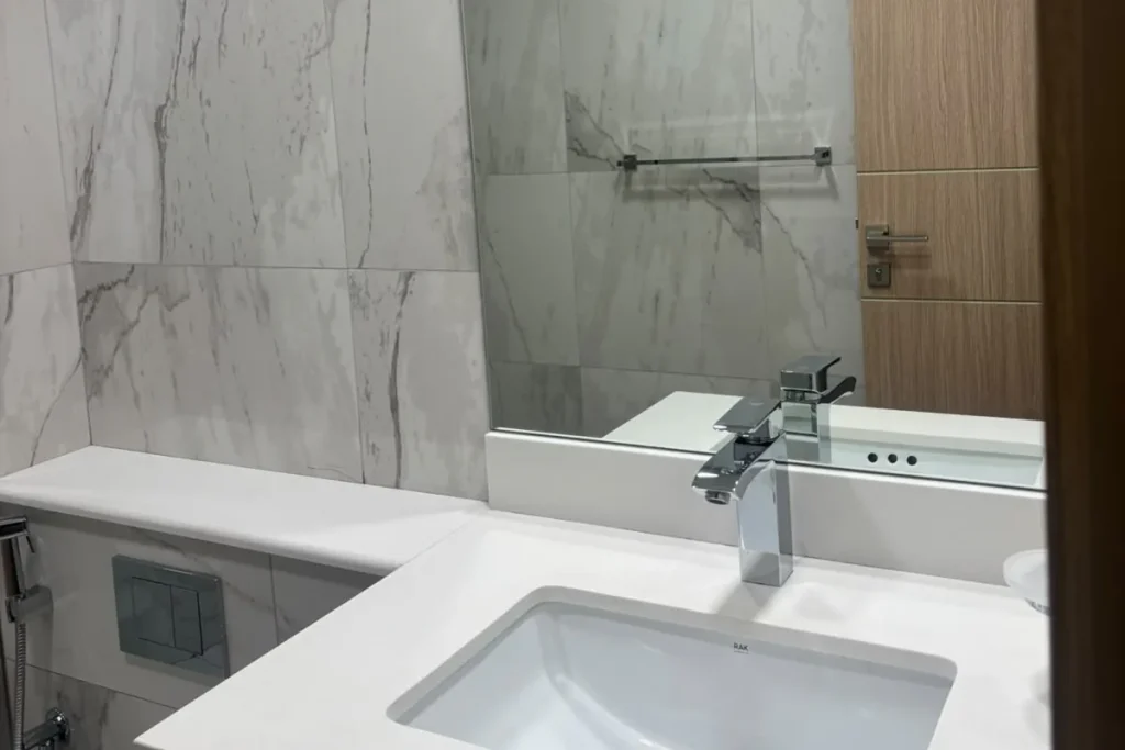 End of tenancy deep clean in Ras Al Khaimah - sparkling bathroom with polished glass, streak free mirror and sanitised basin