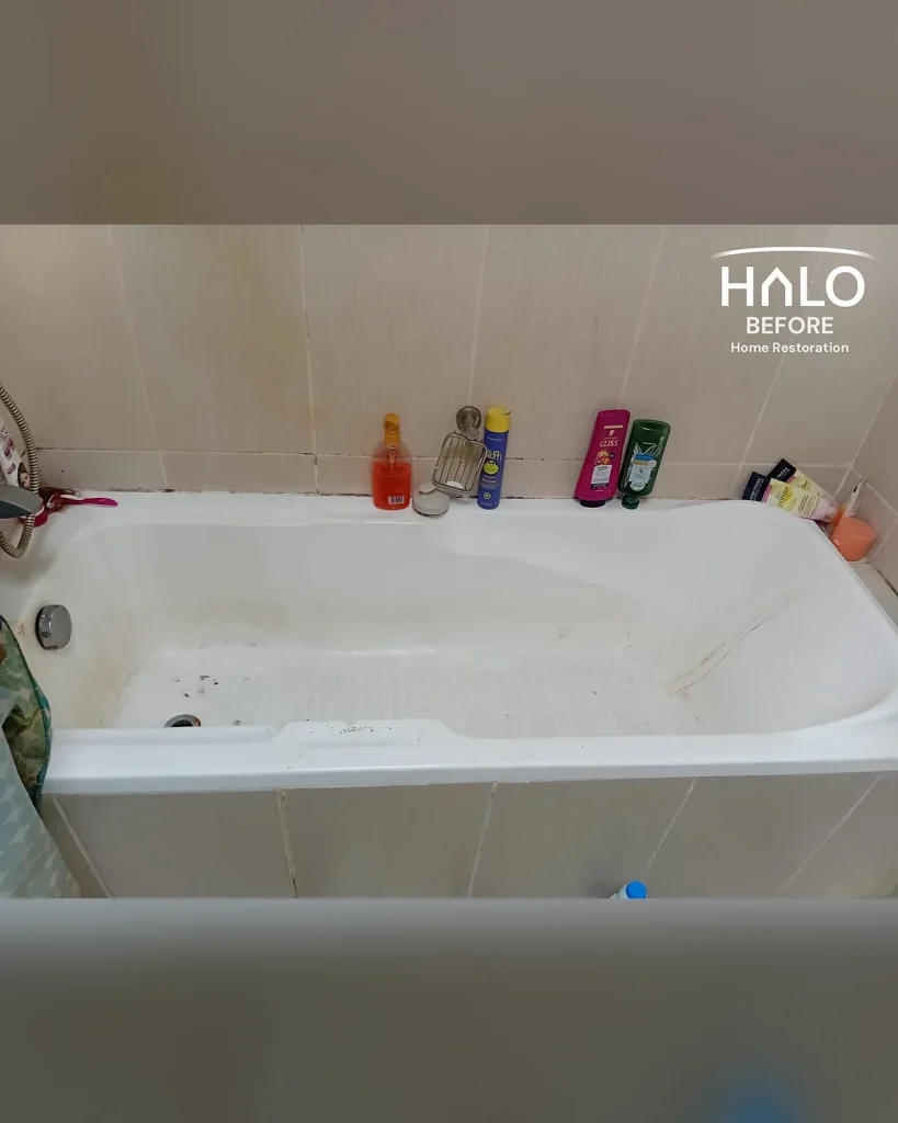 Before limescale removal in Ras Al Khaimah - hard water limescale, soap scum and staining built up across the bath and surrounding tiles